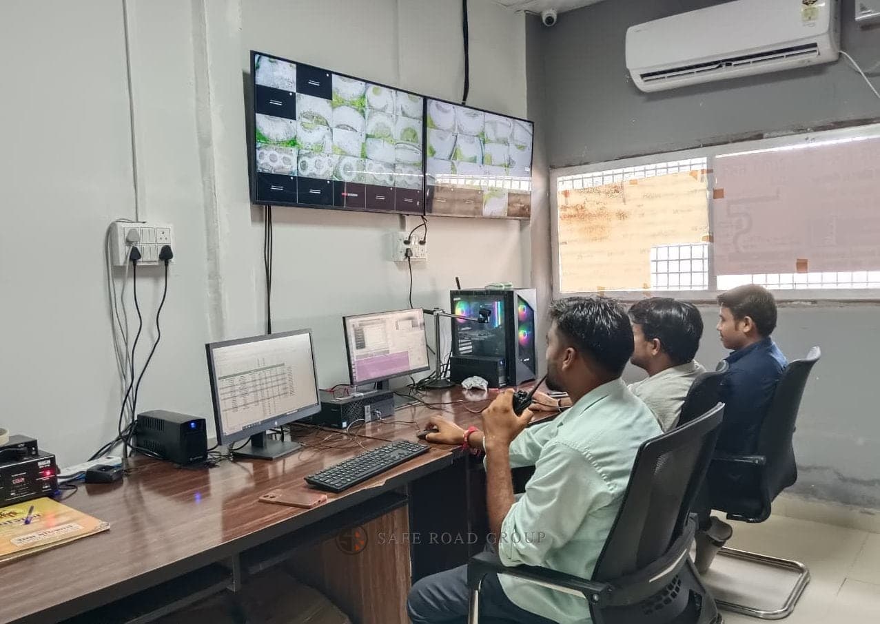 The track control room during a session — the camera wall covering the circuit, the run being scored on the monitors