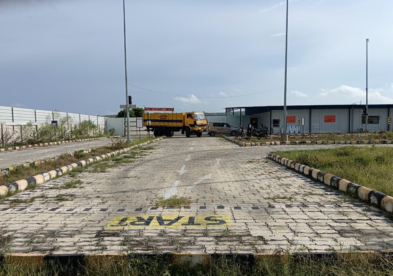 The start of the test lane, the START marking and the sensor studs laid across it, with a training truck waiting at the far end